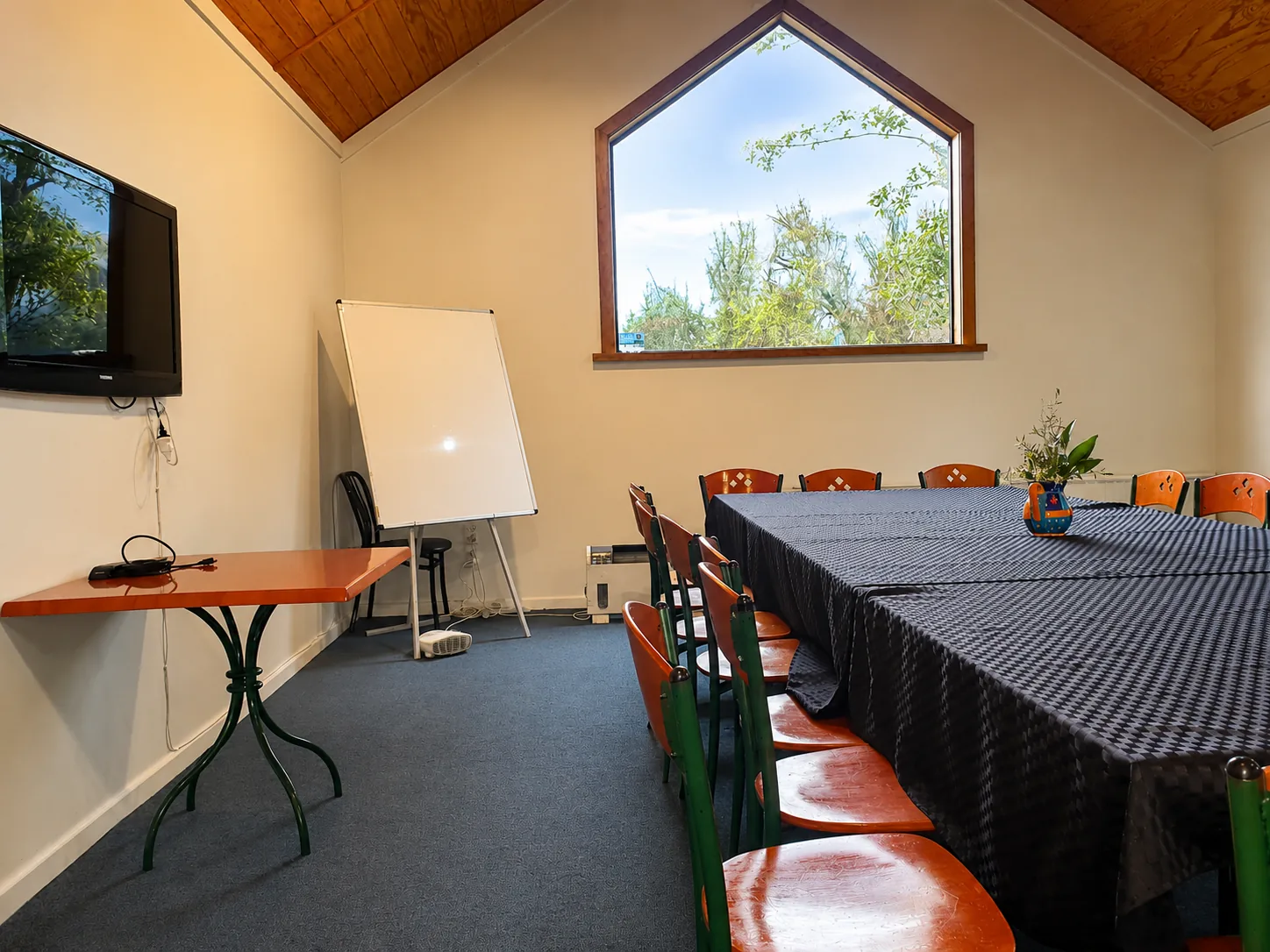 The Beechwoods meeting room set up with a long table, whiteboard and large screen TV