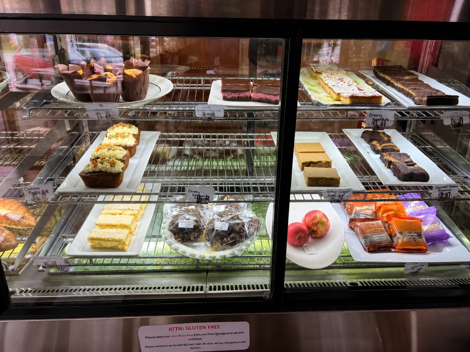 The cabinet filled with slices, cakes and gluten-free baking