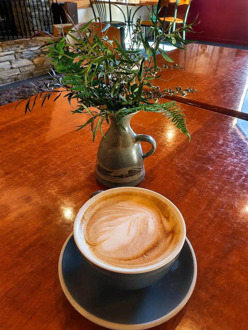 A flat white on a timber table at Beechwoods Café